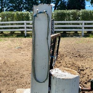 Gold beaded necklace with turquoise leather detail and button closures